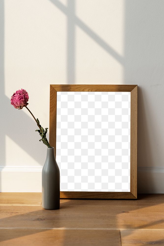 Dried pink peony flower in a gray vase by a wooden frame mockup on the floor