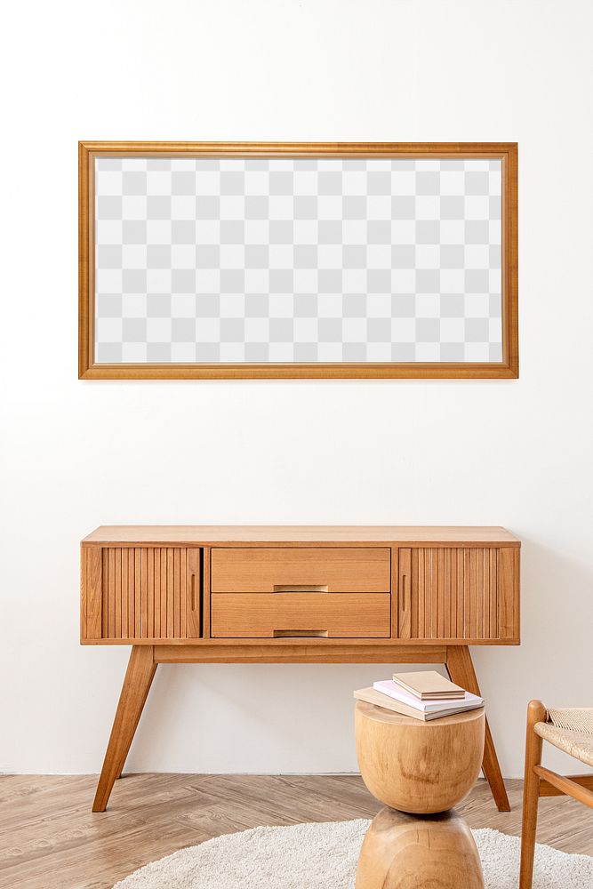 Picture frame mockup above a wooden sideboard table 