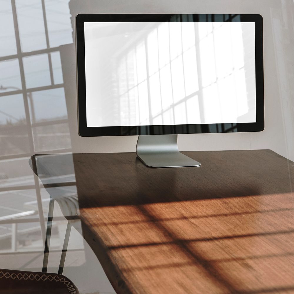 Computer screen mockup, wooden table 