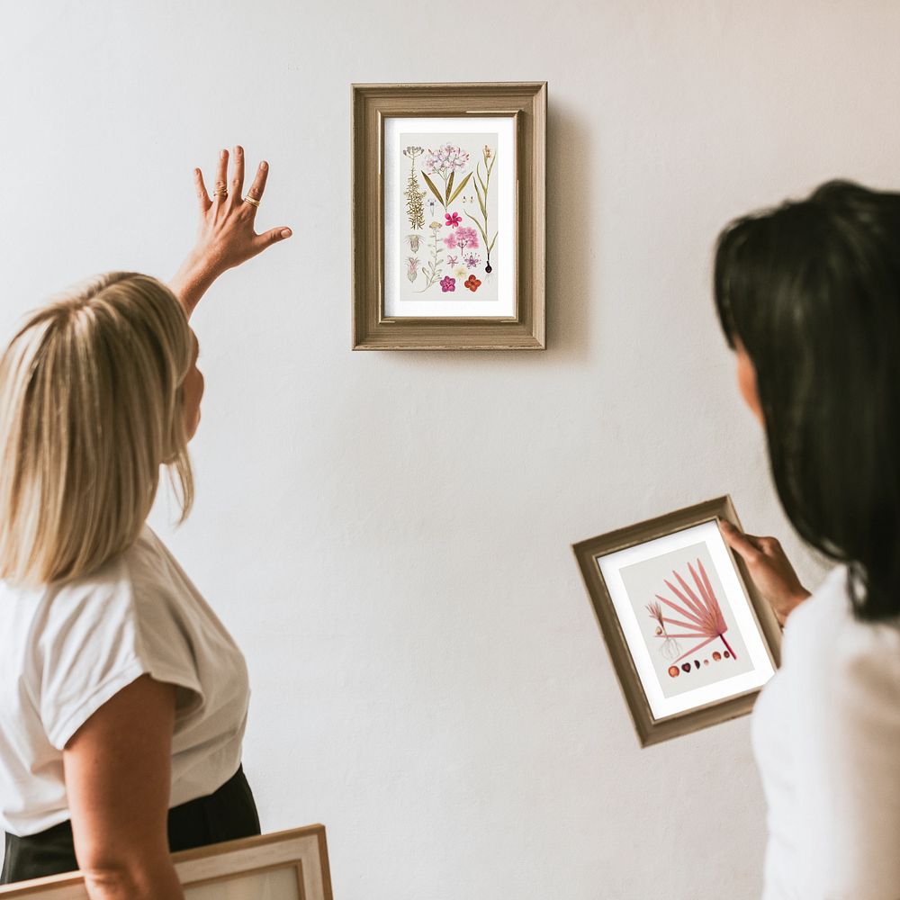 Photo frame customizable mockup, women decorating wall