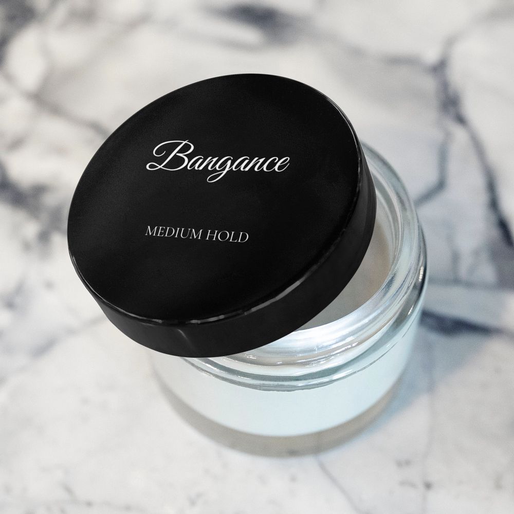 Editable lid mockup on a cosmetic jar containing hair pomade