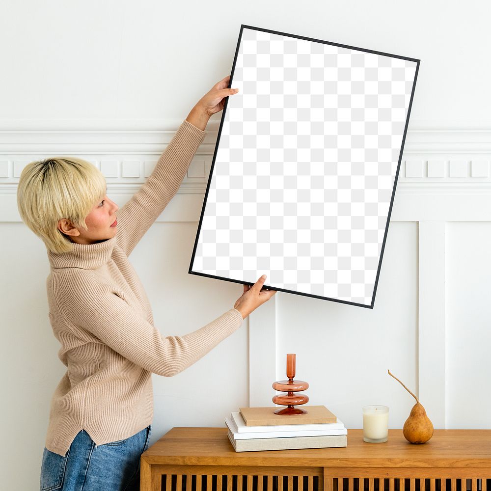 Woman hanging a photo frame on a white wall mockup