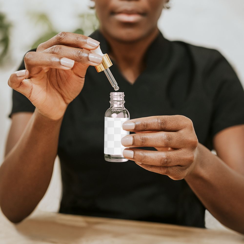 Serum bottle png mockup in African American woman’s hands, transparent design