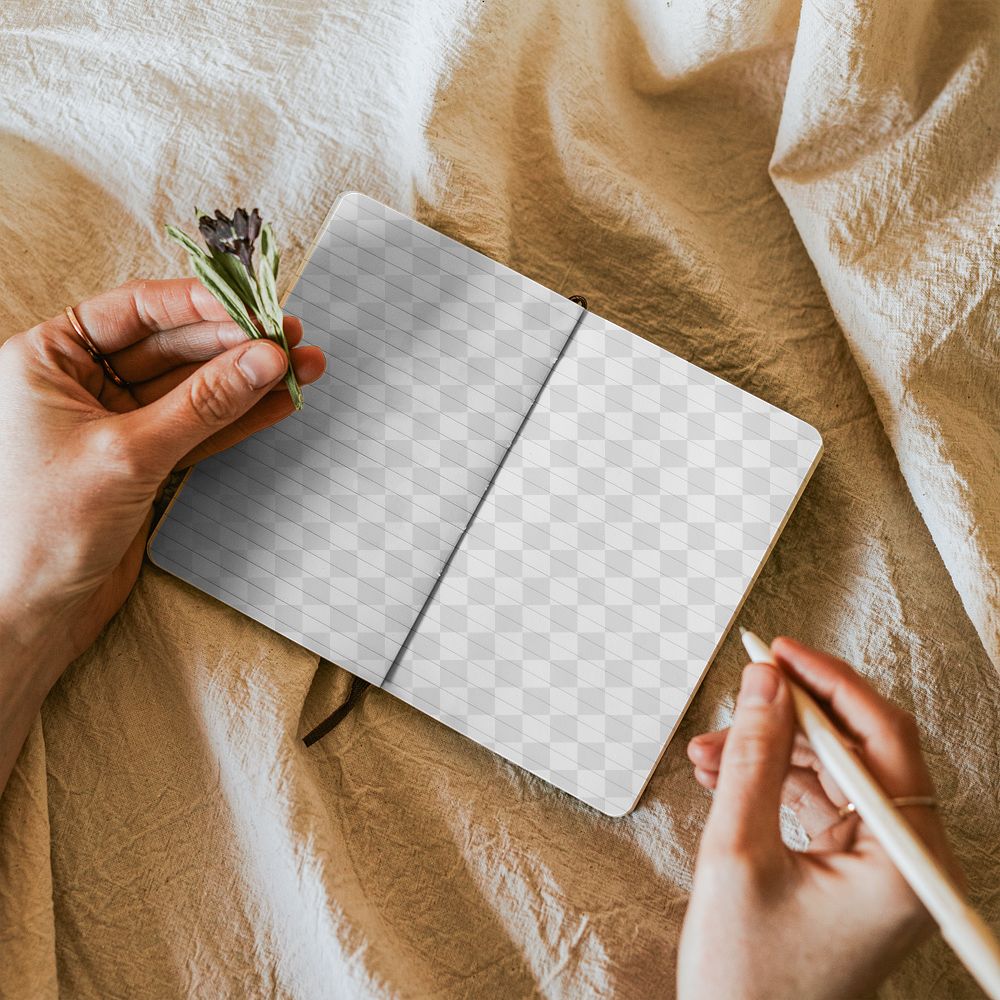 Open notebook png mockup with flowers on linen blanket