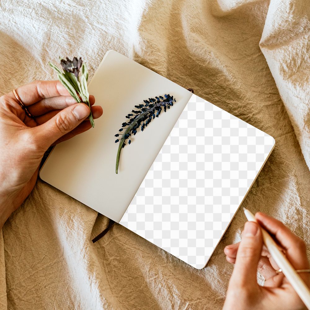 Open notebook png mockup with flowers on linen blanket