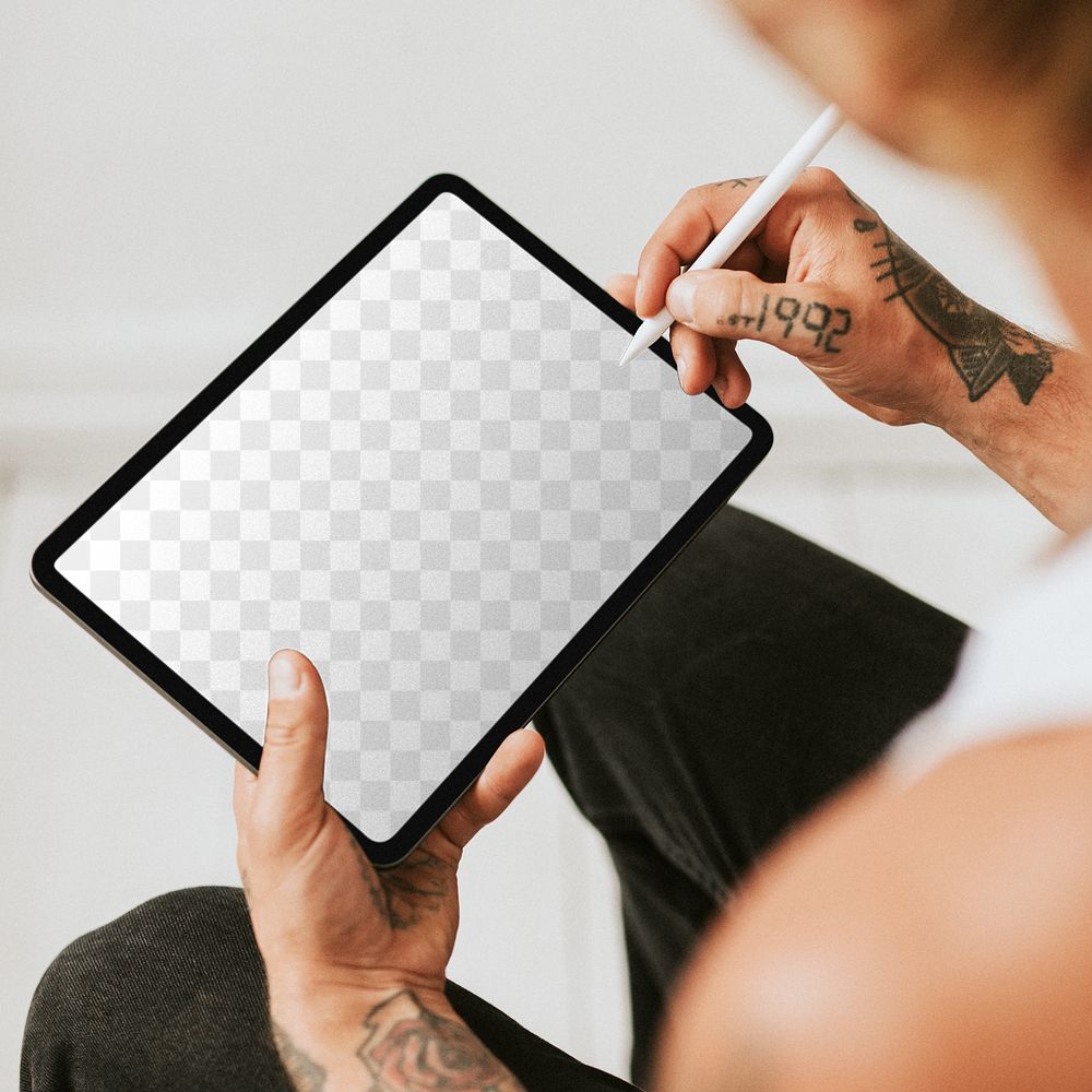 Tablet screen mockup png in the lap of a tattoed man