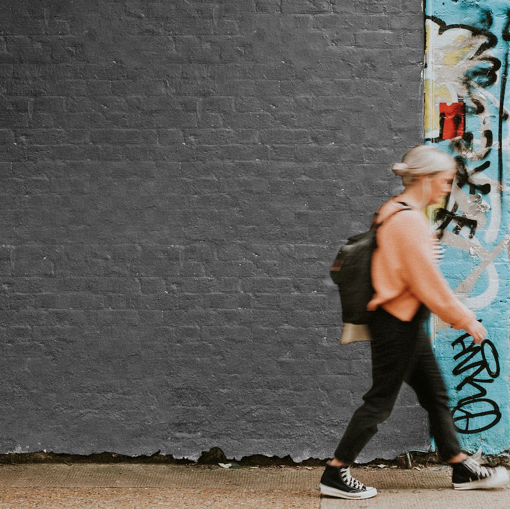 Wall mockup png with a woman walking past