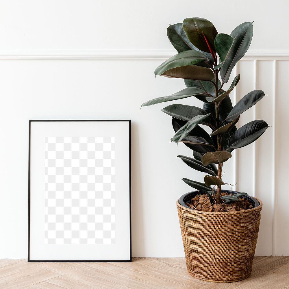 Picture frame mockup by a rubber plant on a wooden floor