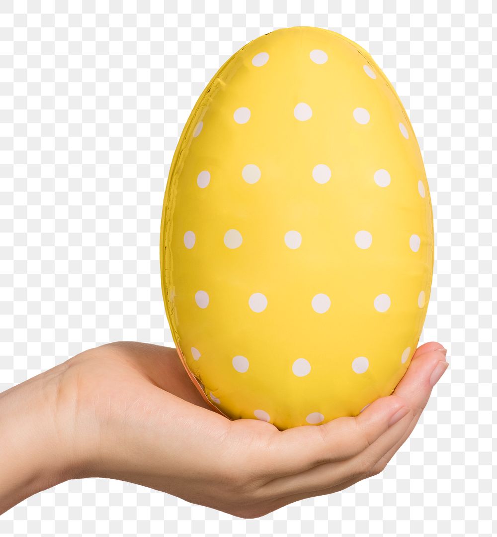 Hand holding a white polka dot patterned yellow egg design element