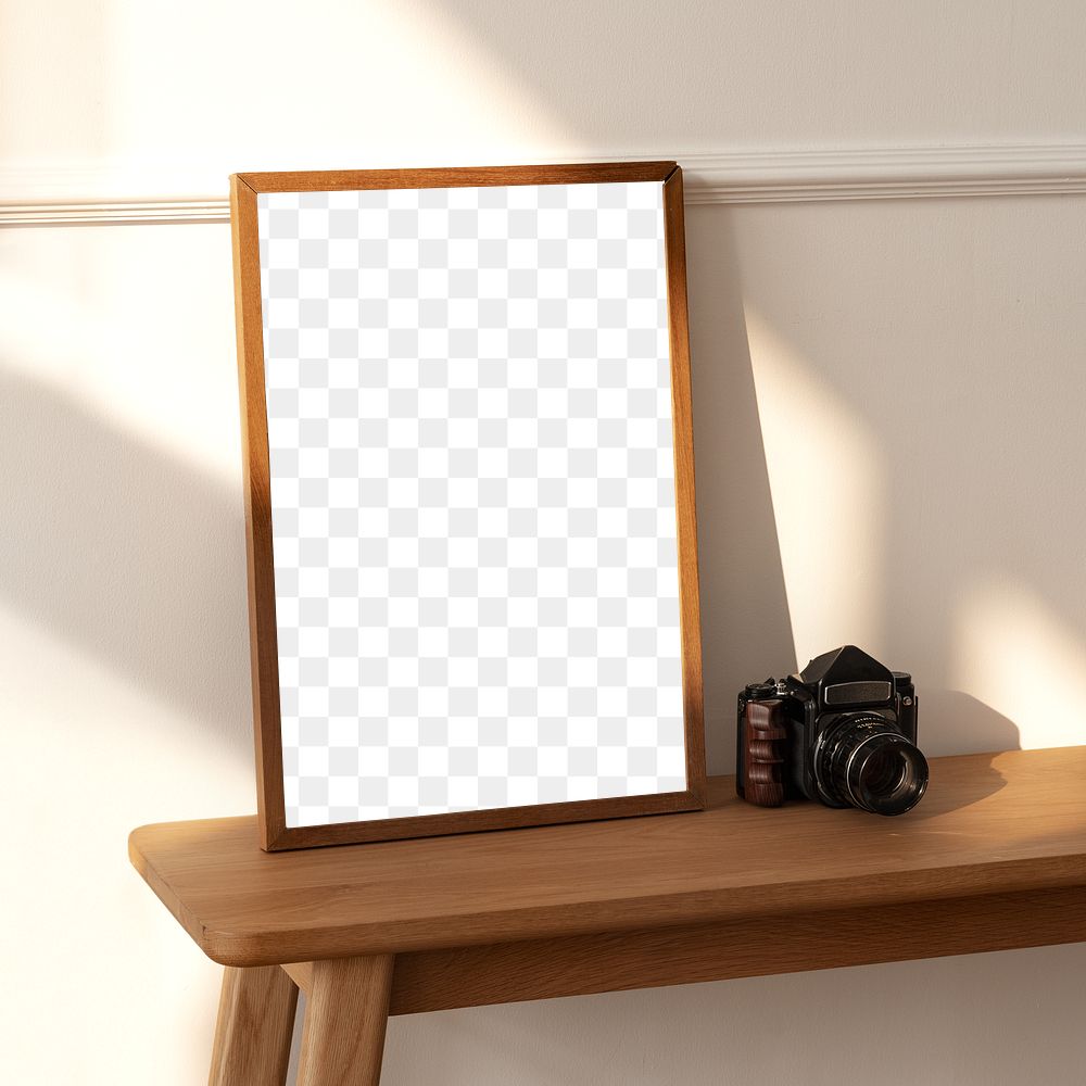 Picture frame mockup on a wooden sideboard table with an analog camera 