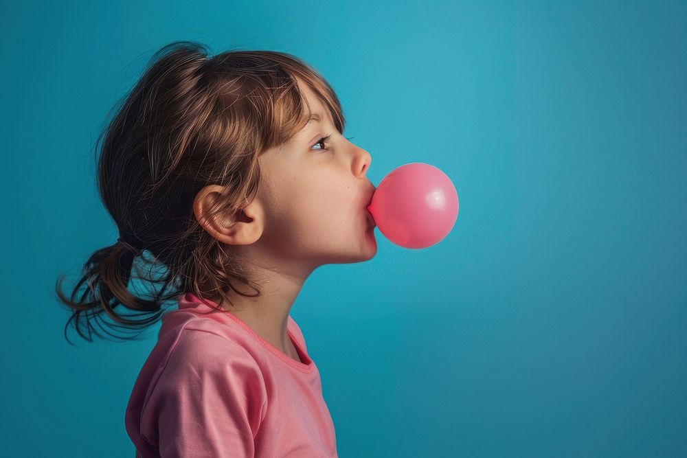 Kid blowing bubble gum balloon female person.