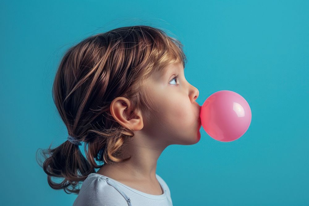 Kid blowing bubble gum balloon female person.