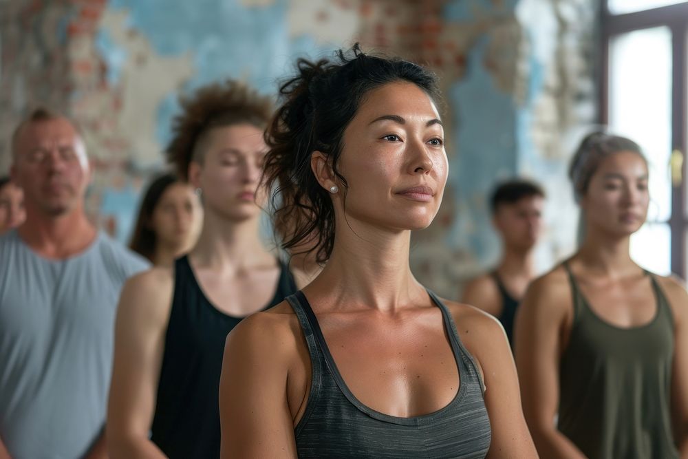 People learning Yoga class female undershirt sweating.