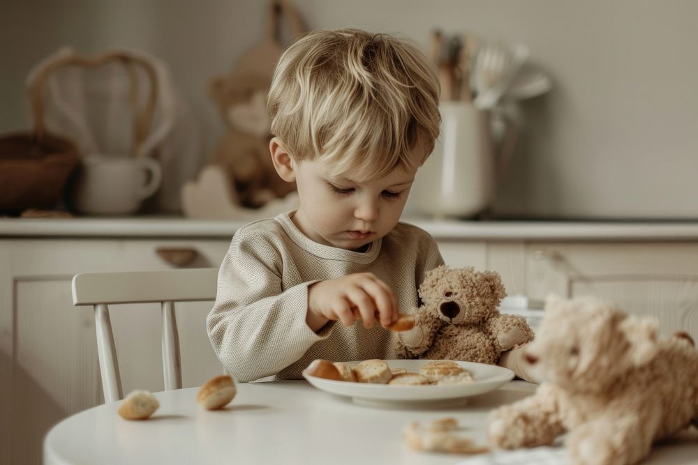 Child playing teddy bear food person biting.