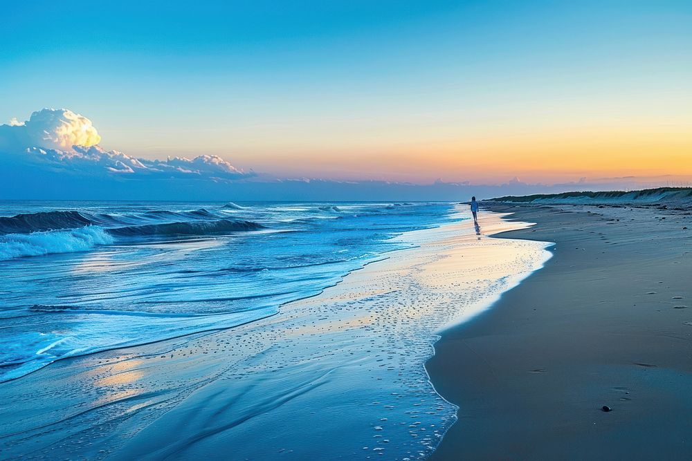 Walking along the beach during sunset shoreline outdoors horizon.