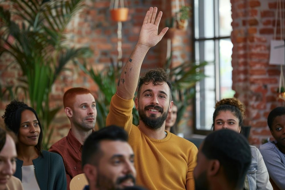 Ambitious male employee raise hand ask question female man furniture.