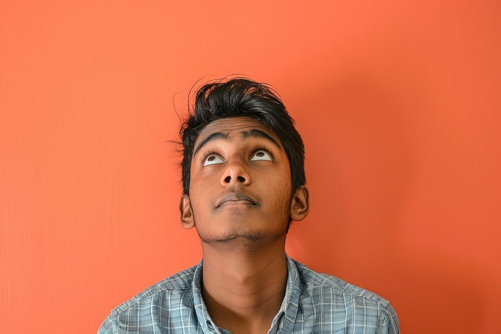 Indian student looking upwards portrait photography surprised.