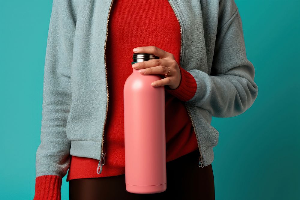 Person holding water bottle cylinder clothing knitwear.