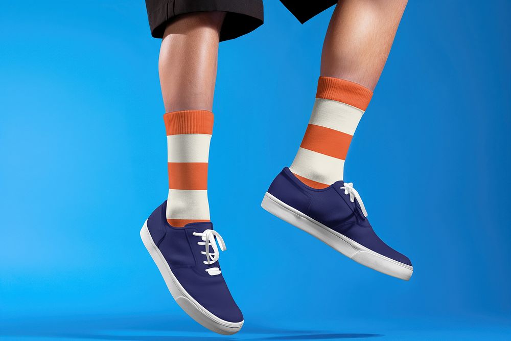 Man in striped orange socks and navy blue canvas shoes
