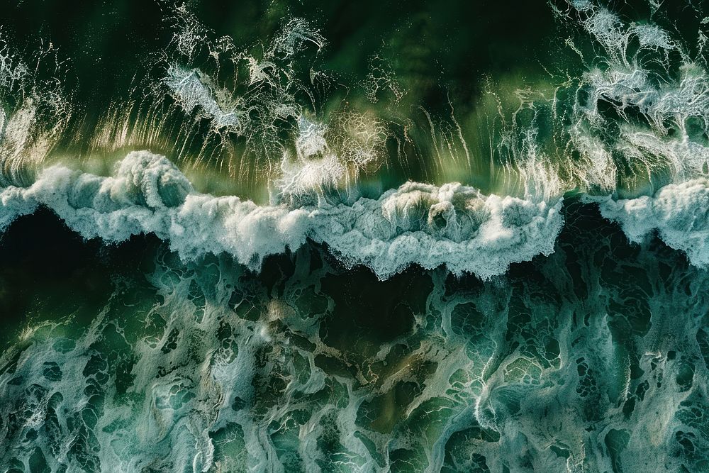 Waves in an ocean water aerial view shoreline.