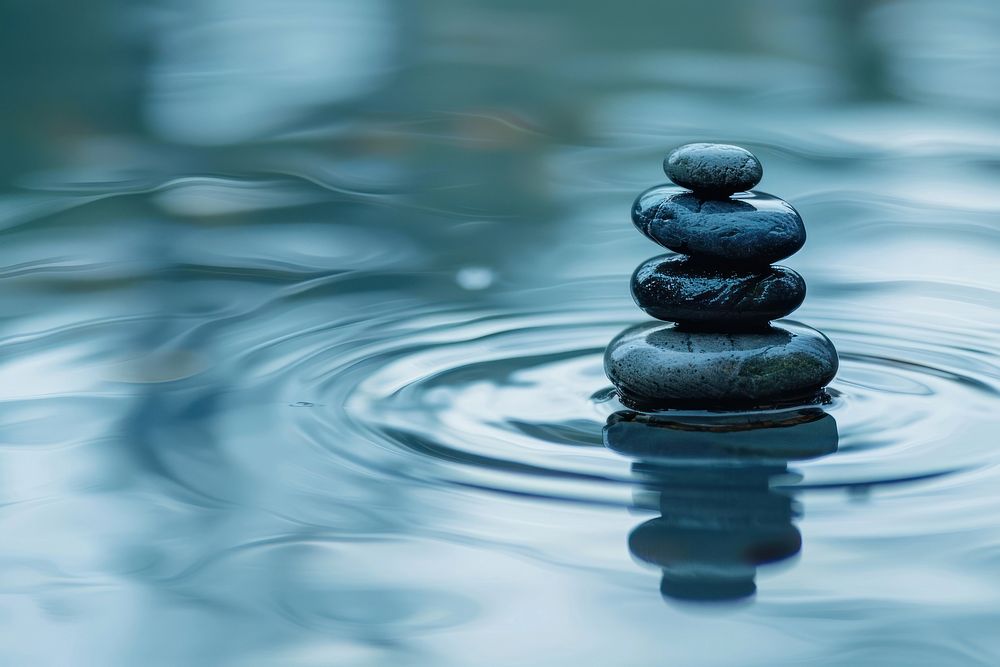 Stones balanced ripple water outdoors.