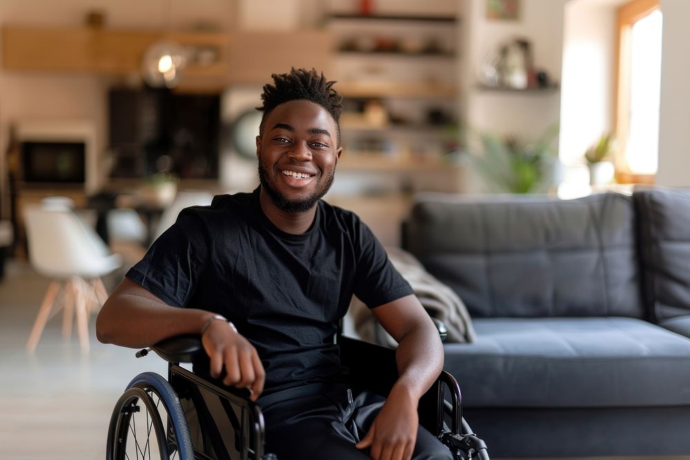 Young man sitting in a wheelchair furniture person human.