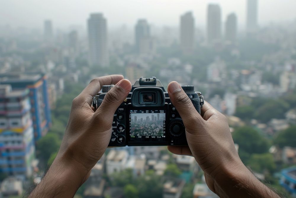 Hands holding camera photography urban city.