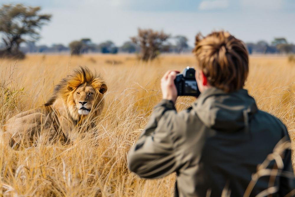 Man holding camera photography lion electronics.