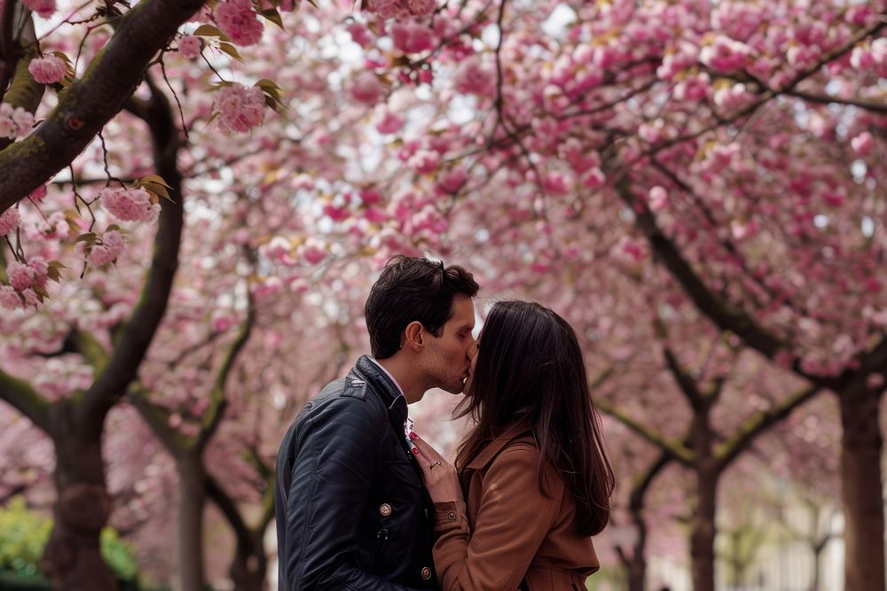 Couples sharing a kiss blossom photo cherry blossom.