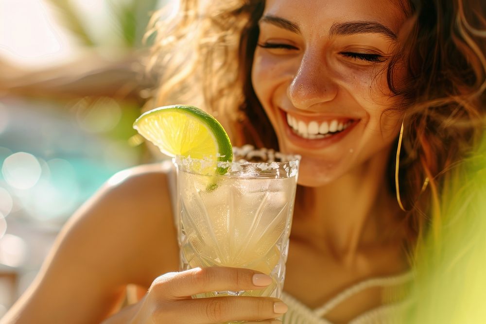 Cheerful young woman enjoying a margarita cocktail beverage produce person.