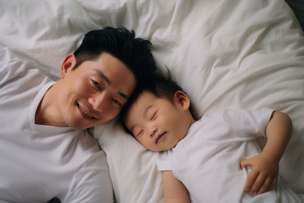 Happy japanese dad and baby photo bed photography.