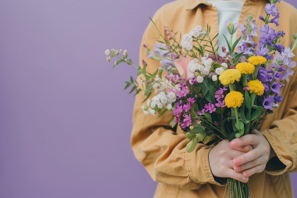 Person holding flower bouquet asteraceae clothing blossom.