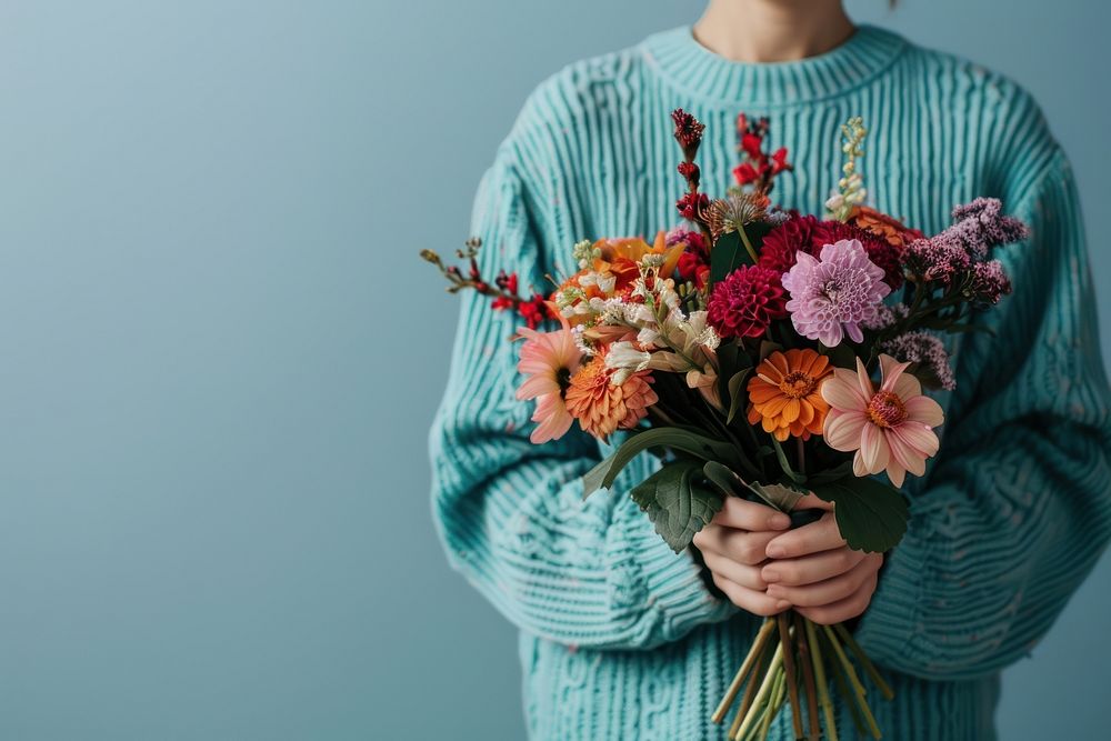 Person holding flower bouquet clothing knitwear graphics.