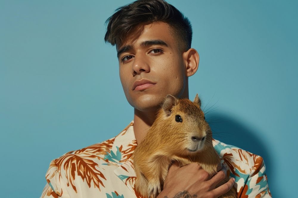 Hispanic man holding capybara portrait photography person.