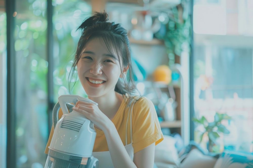 Asian person holding vacuum happy human smile.
