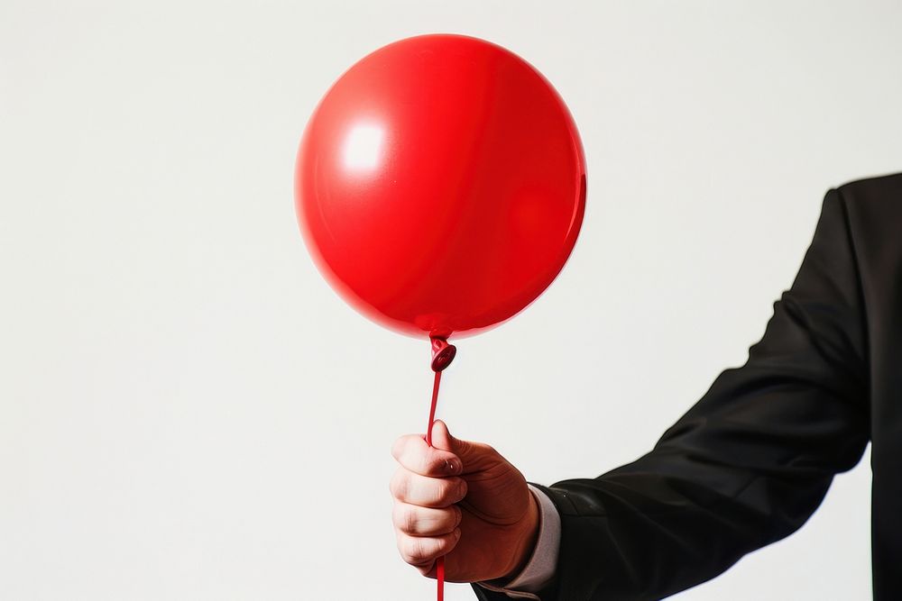 Man holding red balloon person racket sports.