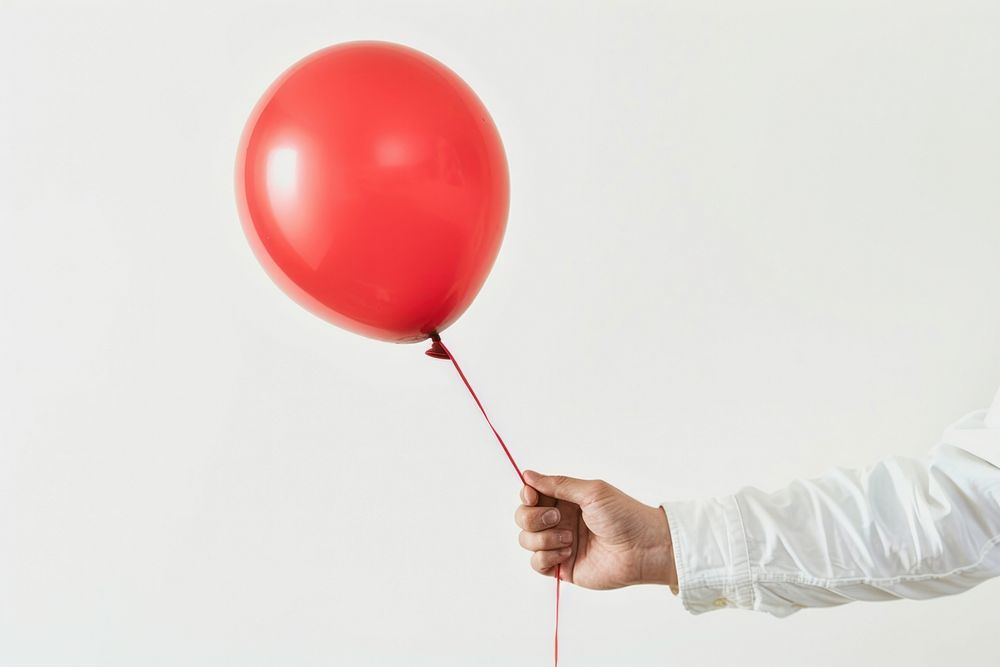 Man holding red balloon.
