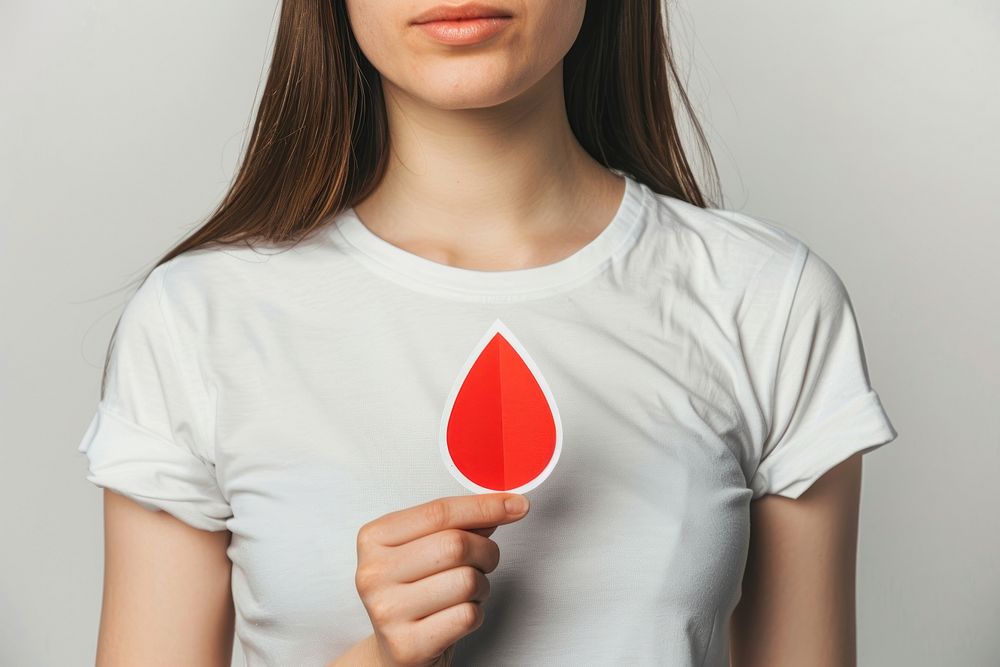 Holding paper red drop shape t-shirt clothing apparel.