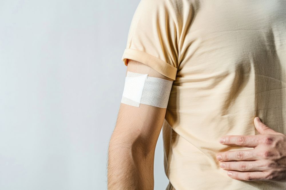Patient in t-shirt with plasters on his arm person human adult.
