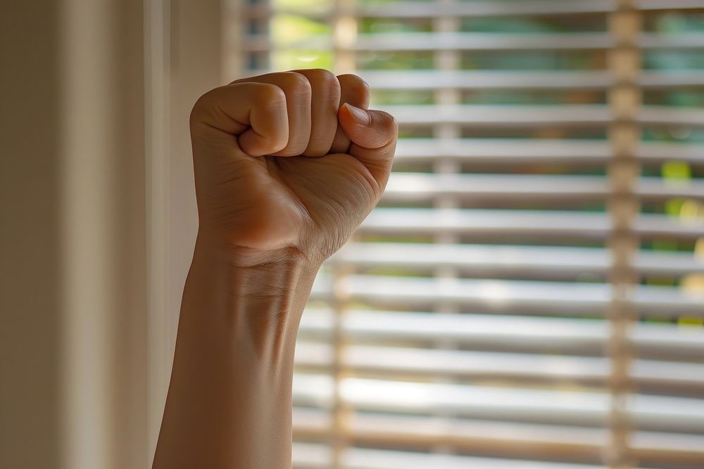 Woman raising a fist person human wrist.