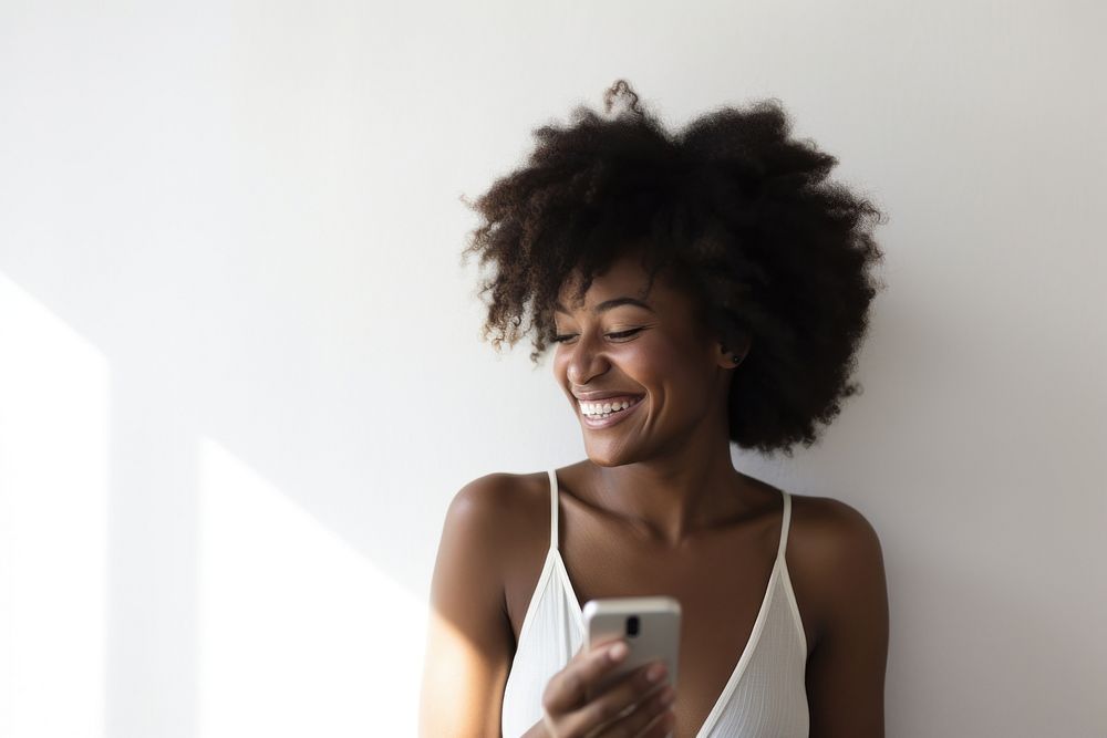 Black woman holding cellphone adult happy electronics.