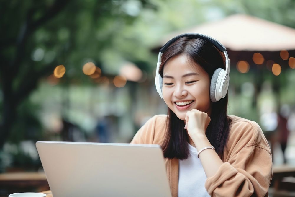 Young asian female student laptop electronics headphones.