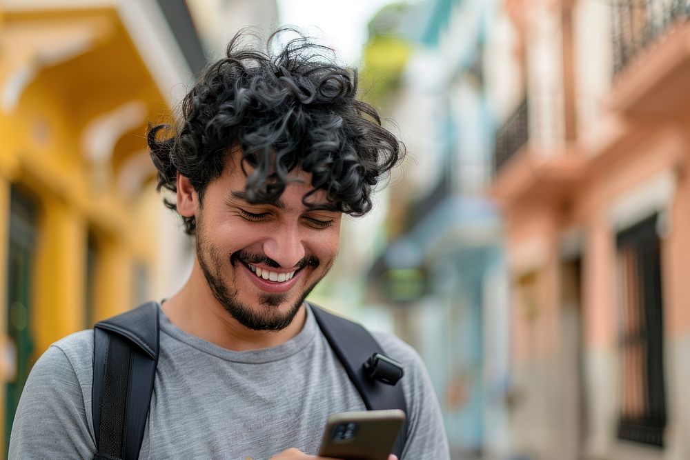 Latin man happy phone hair.