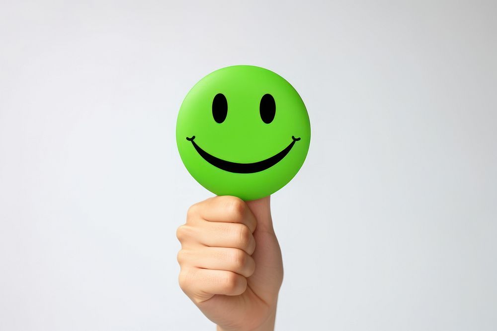 Hands holding paper green happy smile face hand confectionery finger.