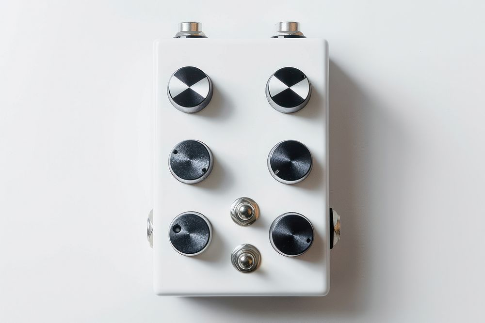 Blank white guitar effect pedal indoors skating switch.