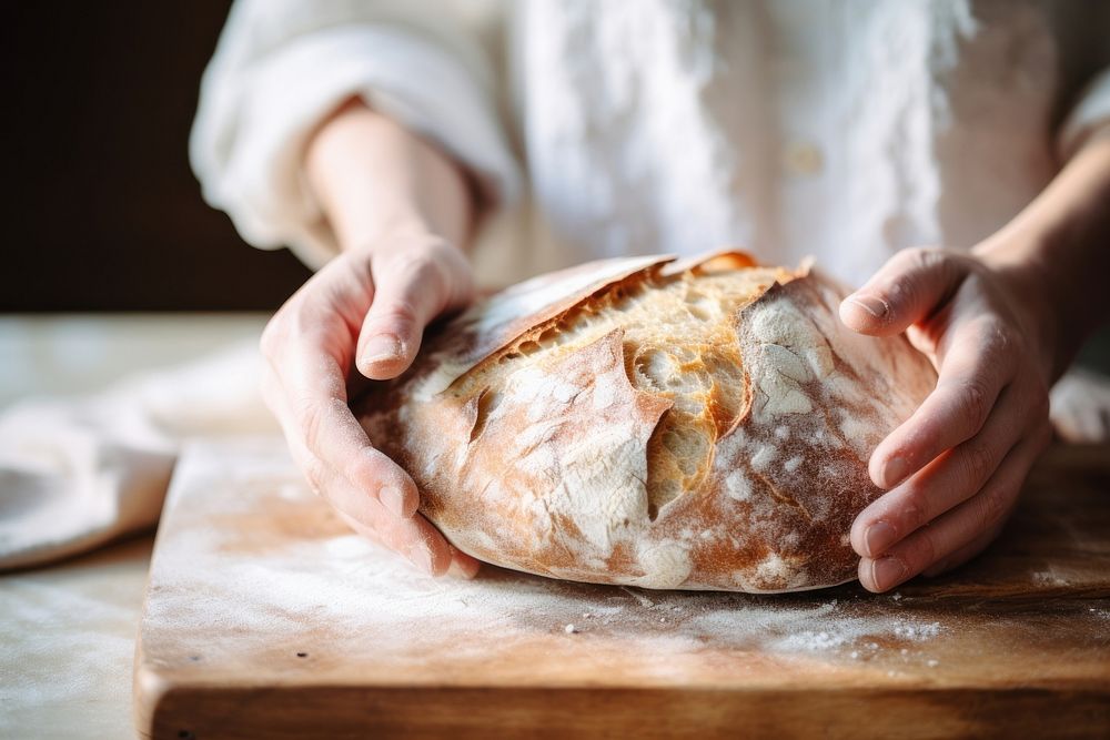 Woman hand on sourdough bread on board cooking person human.
