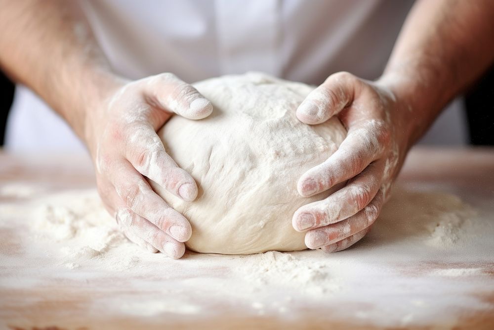 Hands kneading bread dough cooking person diaper.