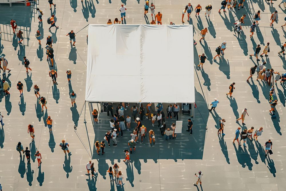 Crowded people walking entrance contruction with close up blank white tent roof and blank white sign in front of tent roof…