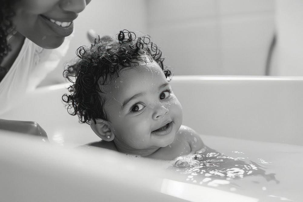 Mom hand pick up blackbaby happy in tub photo photography portrait.