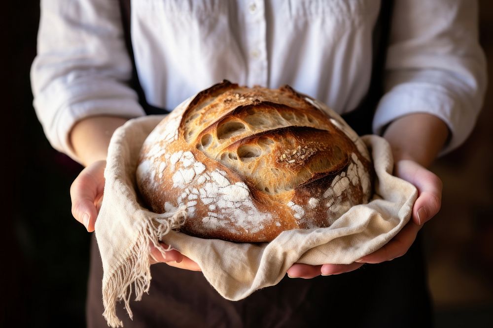 Woman hands holding tray of fresh baked sourdough baguette person bread.